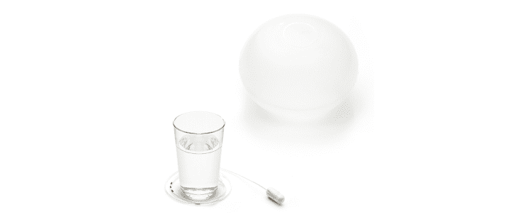 Gastric Balloon pill and a glass of water 