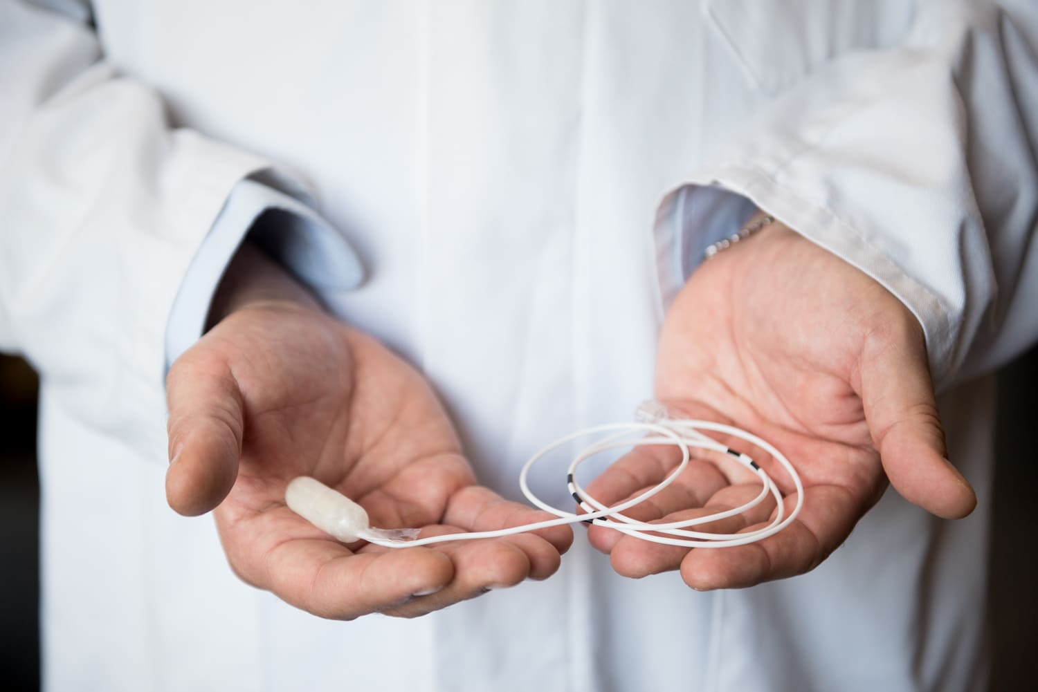 A Doctor holding the Allurion Gastric Capsule in his hands