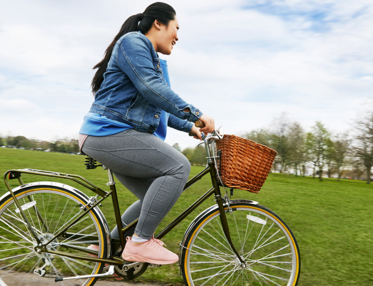 A lady using the bike as an exercising tool for weight loss