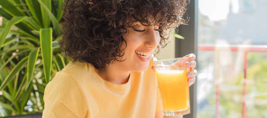 A women drinking orange juice as a part of her diet program for weight loss