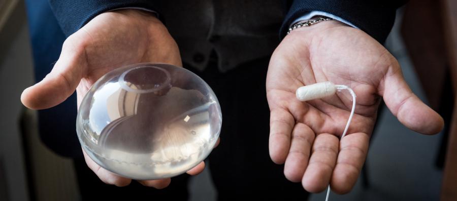 A Doctor holding the Allurion Gastric Balloon and Capsule in his hands