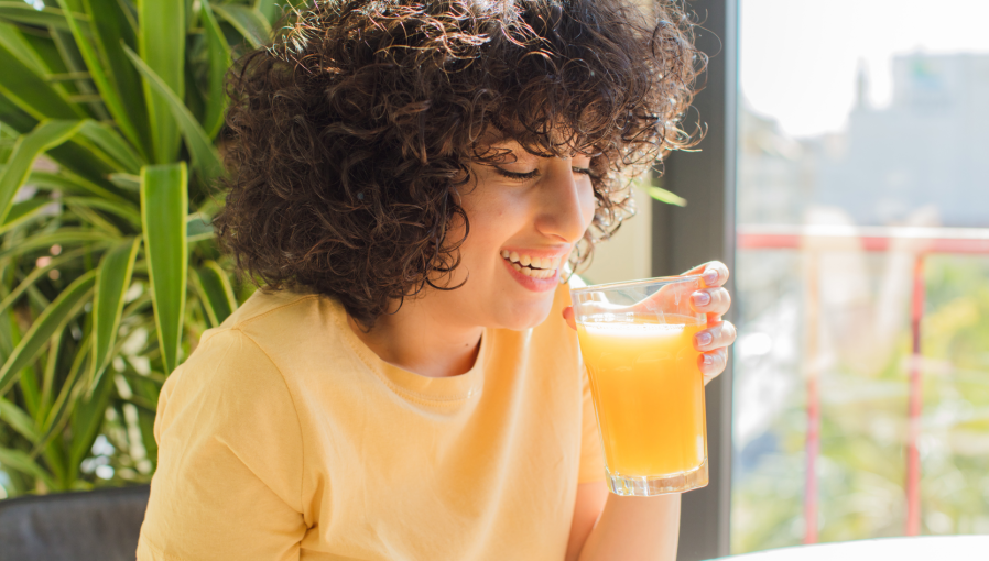 A women drinking orange juice as a part of her diet program for weight loss