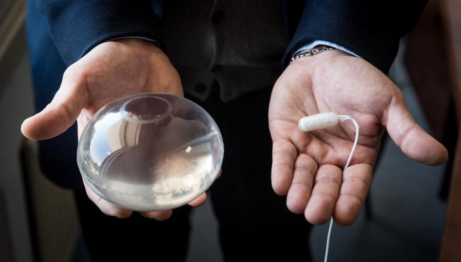 A Doctor holding the Allurion Gastric Balloon and Capsule in his hands