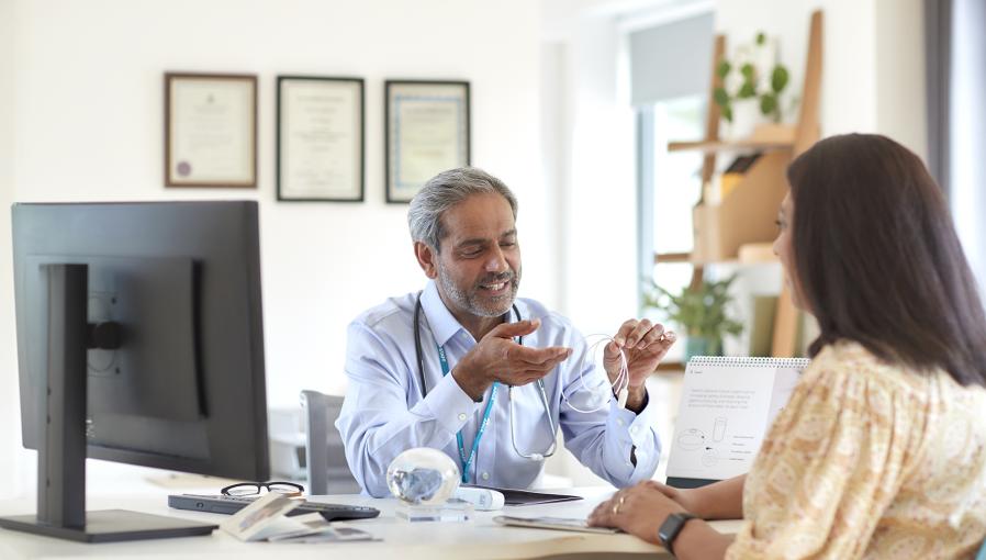 A doctor with his patient talking about the Allurion Balloon