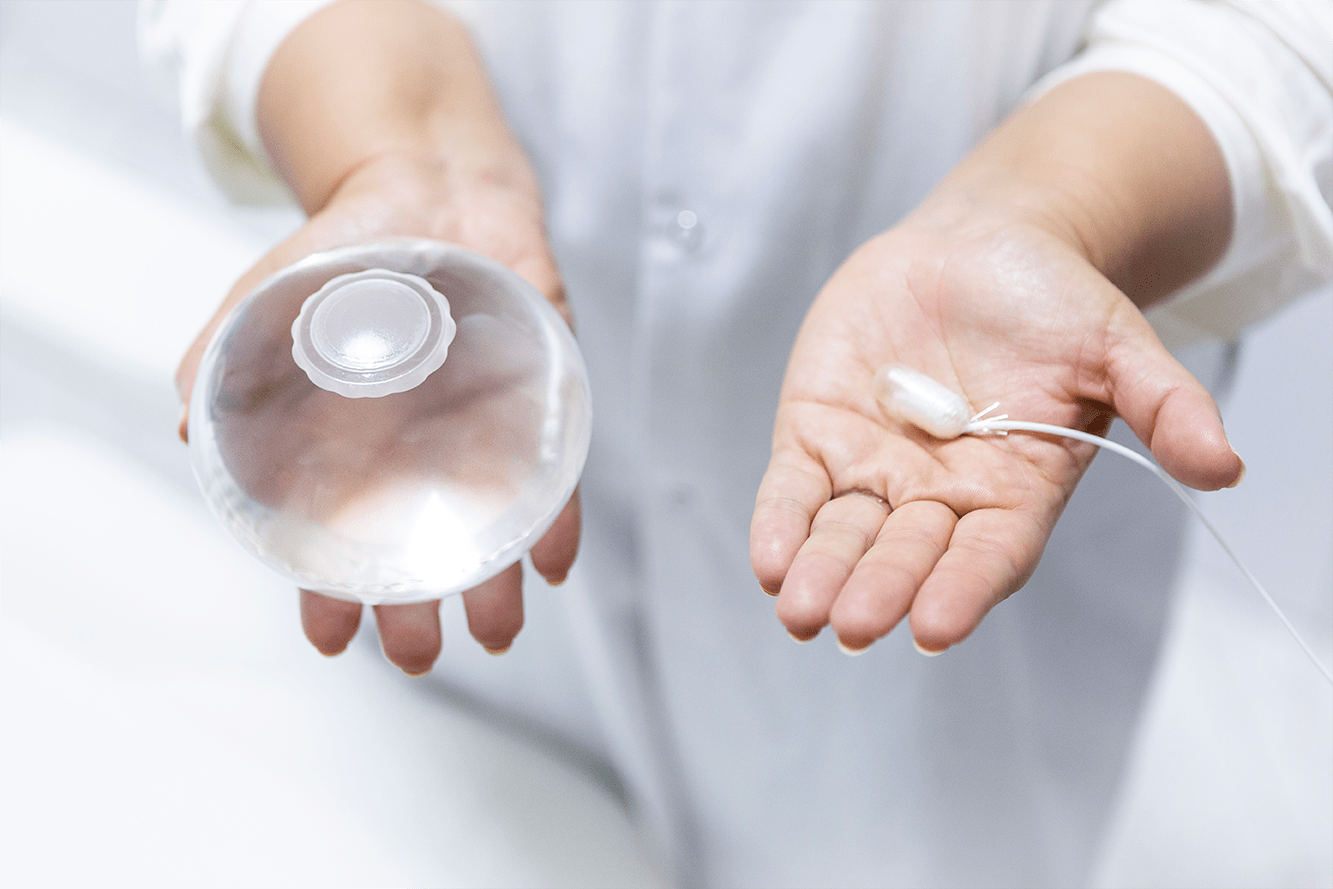 A Doctor holding both the Allurion Gastric Balloon and Capsule in his hands